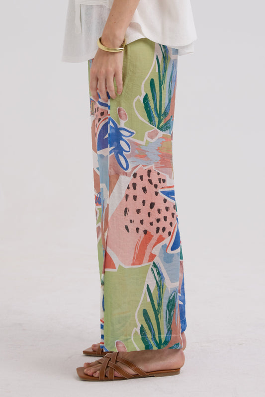 Colorful floral-patterned pants worn by a person on a white background