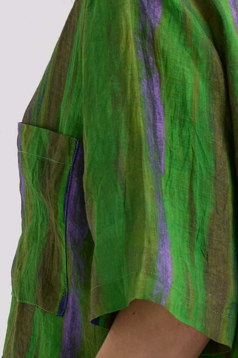 Green and purple fabric with a textured pattern on a white background