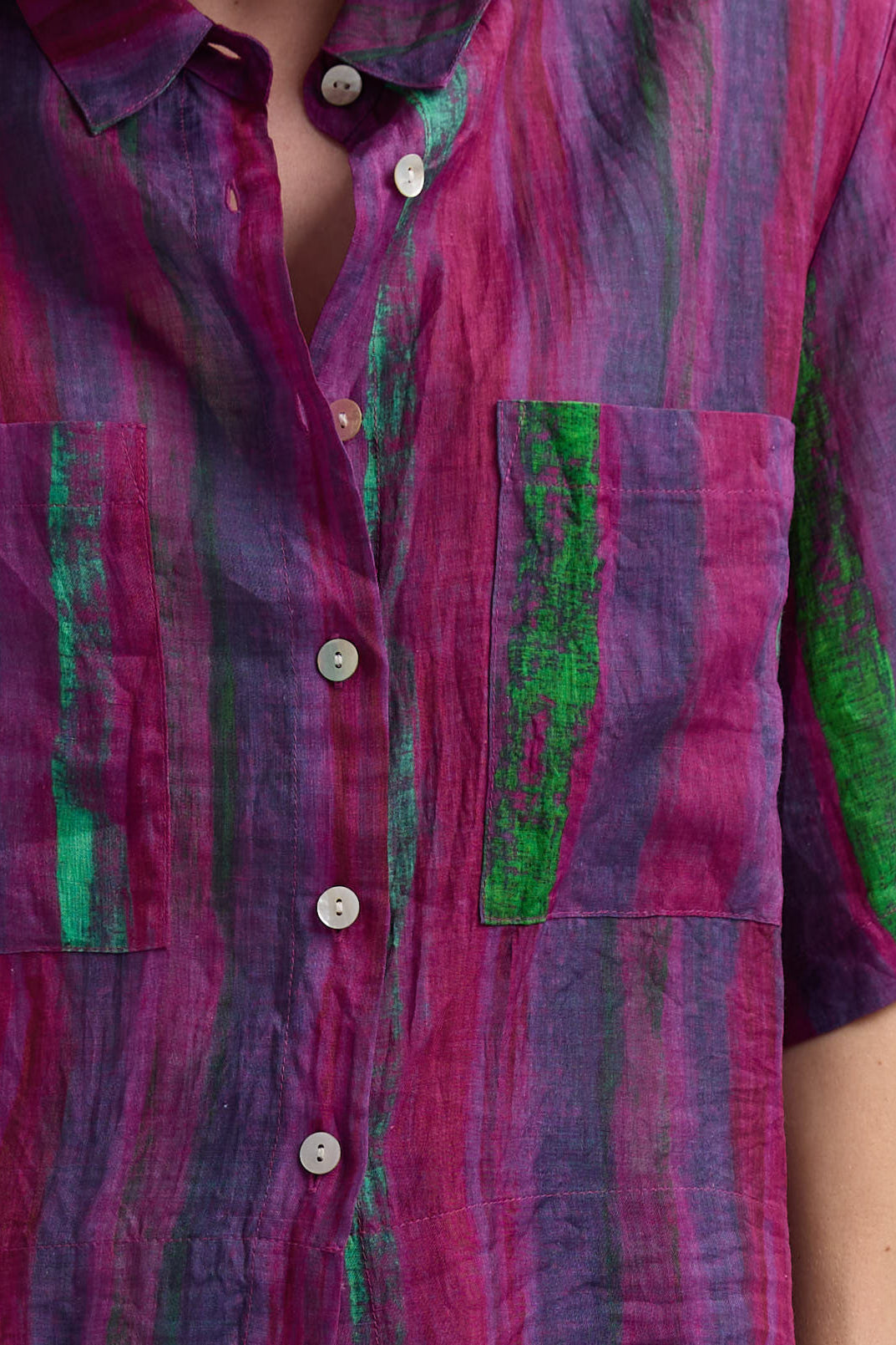 Close-up of a colorful plaid shirt with green accents