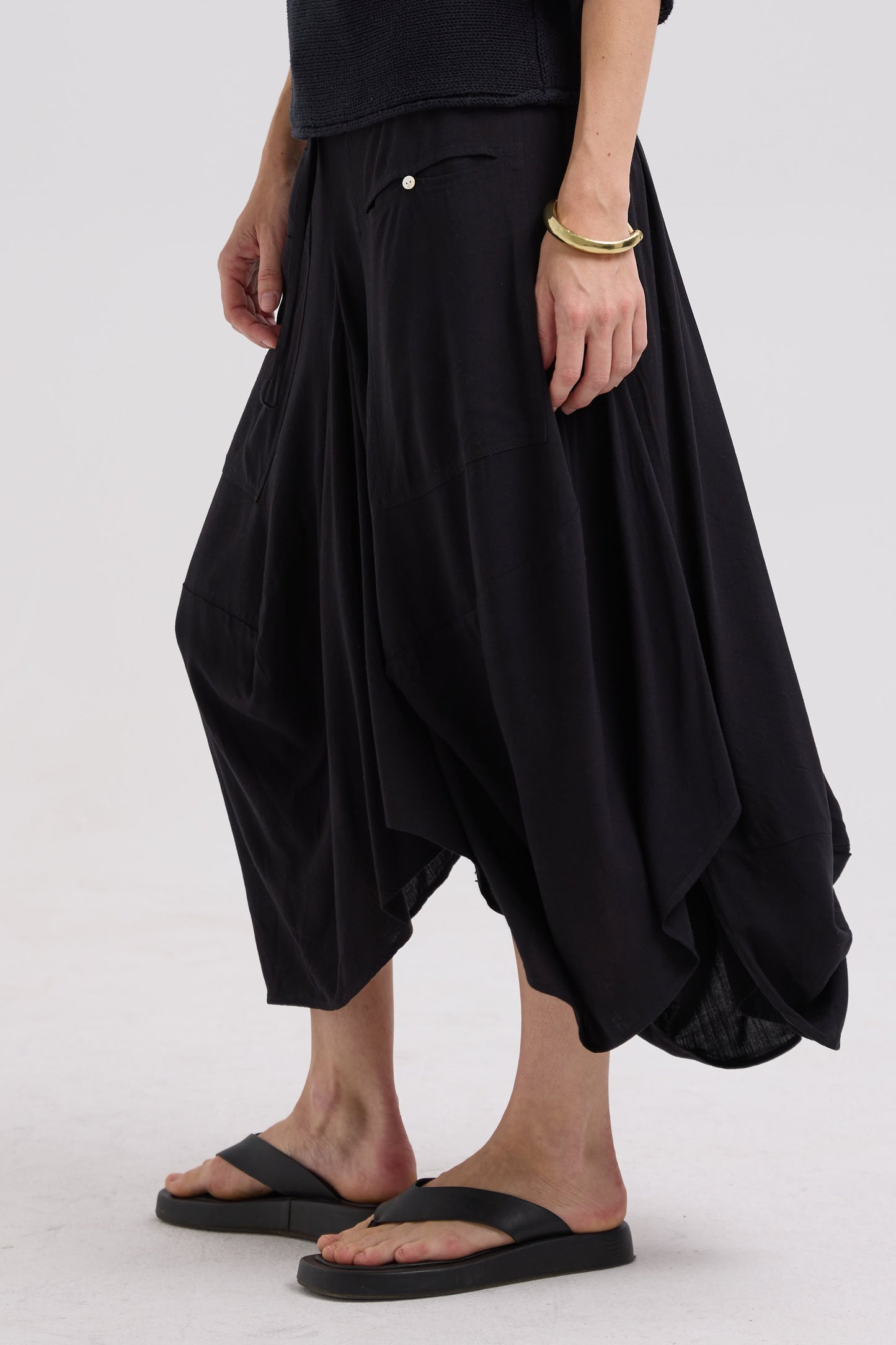 Person wearing black skirt on a white background