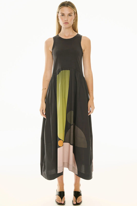 Woman wearing a sleeveless dress with color-blocked design on a white background