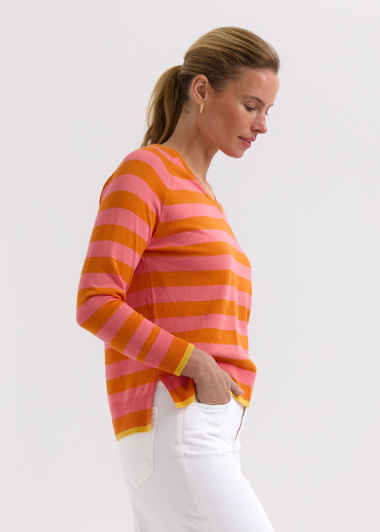 Woman wearing a pink and orange striped sweater against a white background