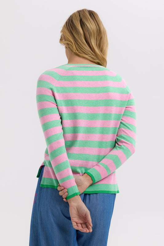 Person wearing a pink and green striped sweater on a white background