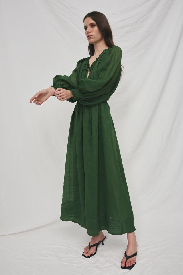 Woman wearing a green dress against a white background
