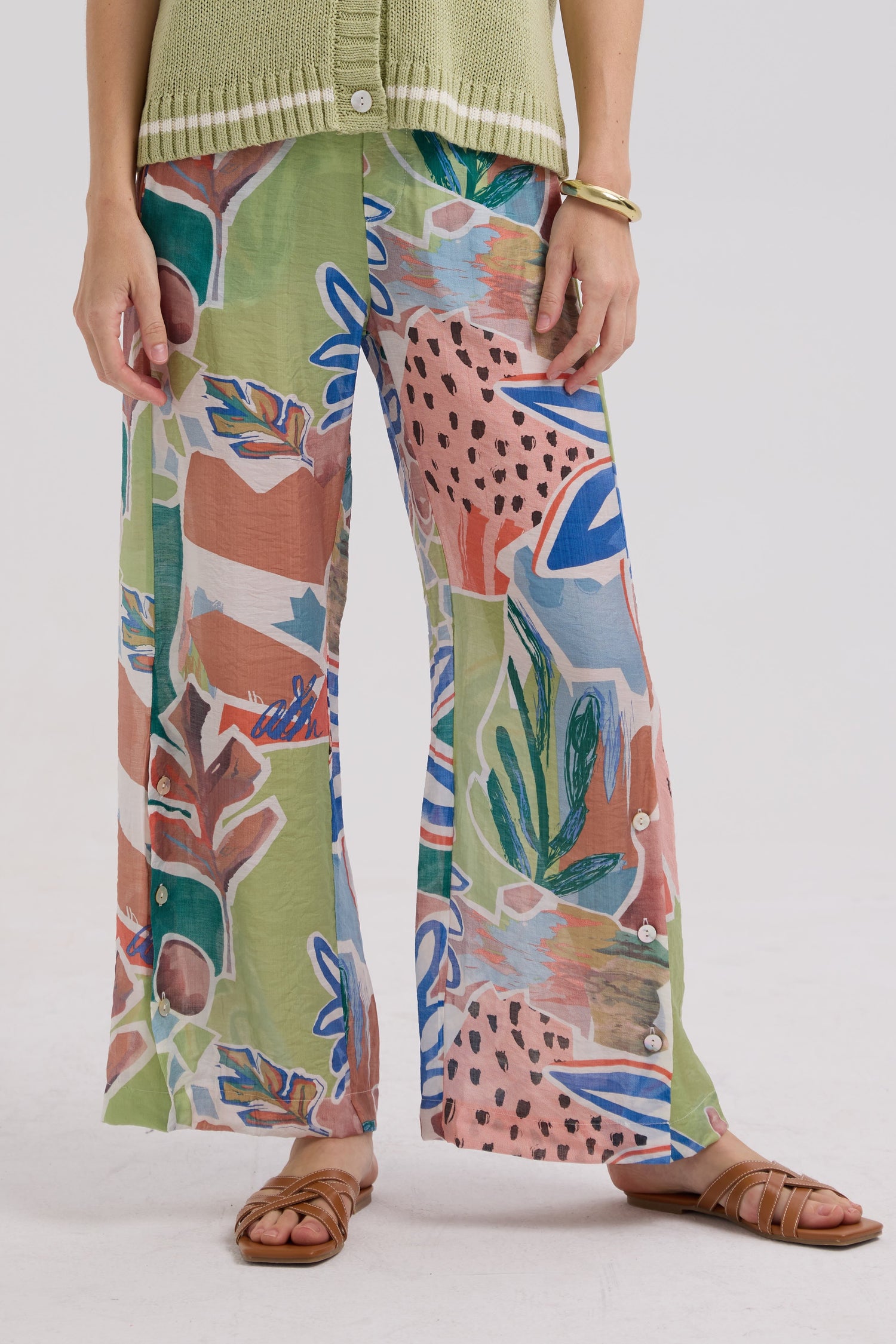 Person wearing colorful patterned pants on a white background