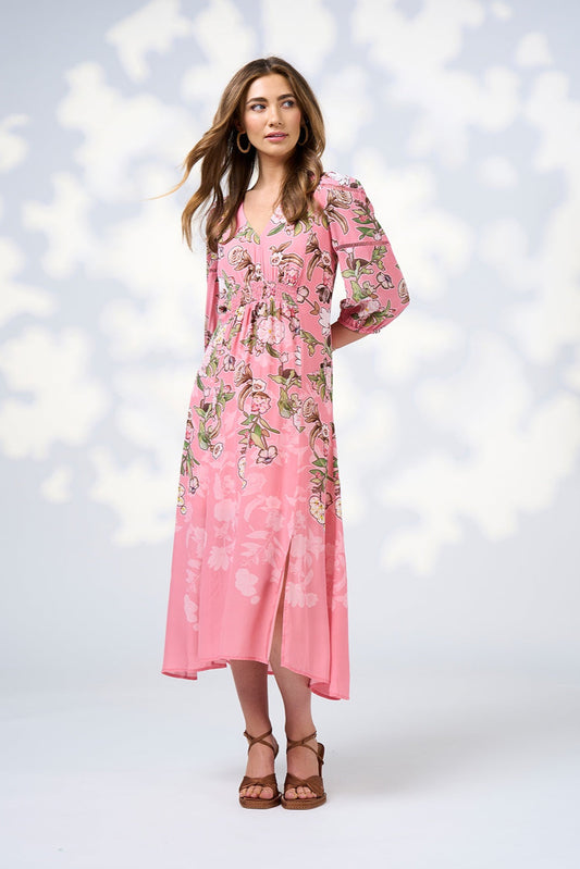 Woman wearing a pink floral dress against a white background