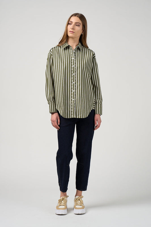 Woman wearing a striped shirt and dark pants on a white background