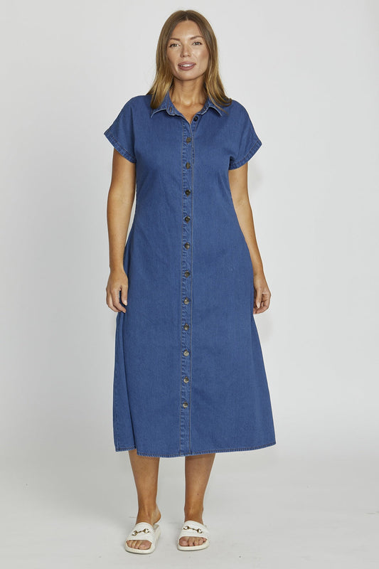 Woman wearing a blue denim dress on a white background