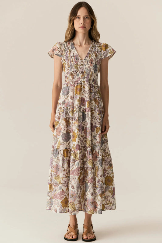 Woman wearing a floral dress on a plain background