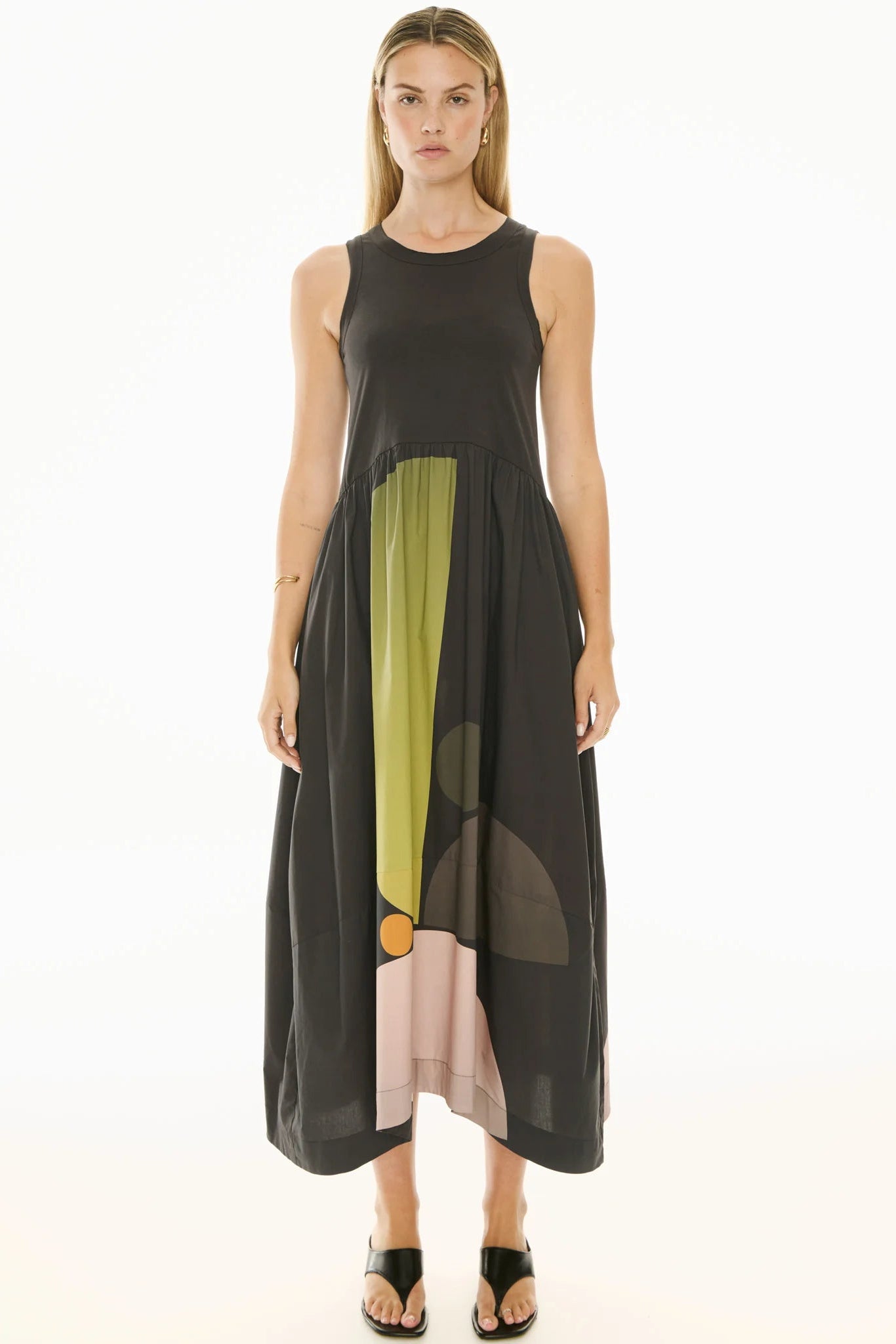 Woman wearing a sleeveless dress with color-blocked design on a white background