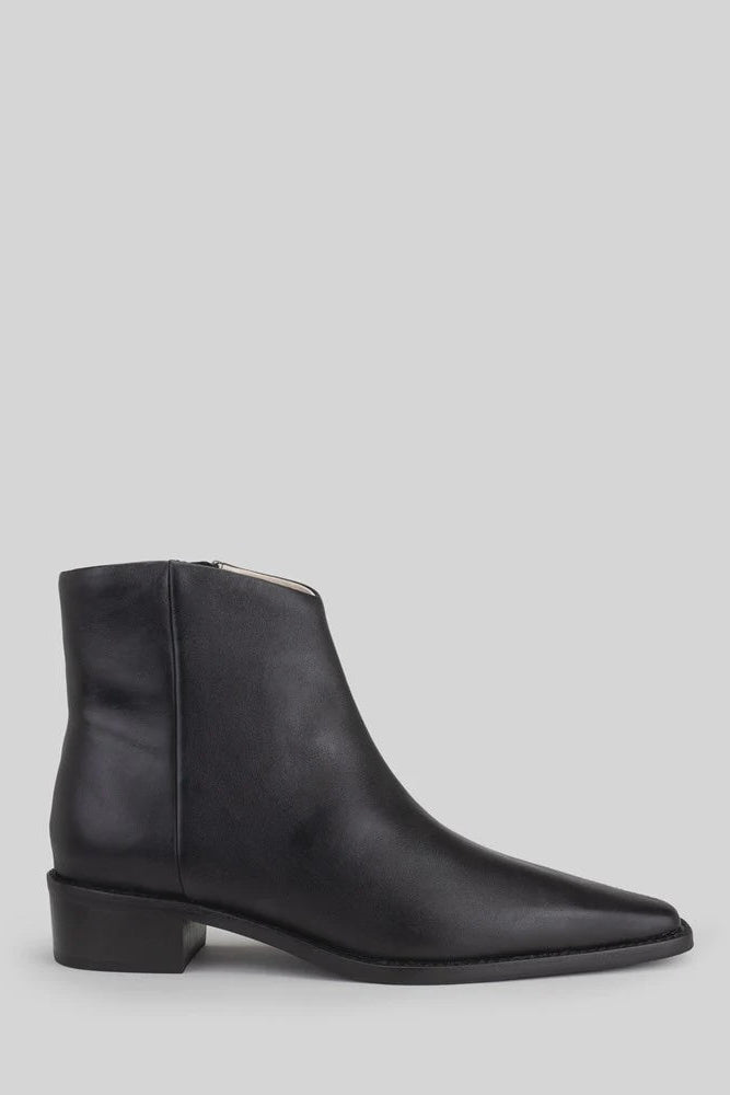 Black ankle boot on a light gray background