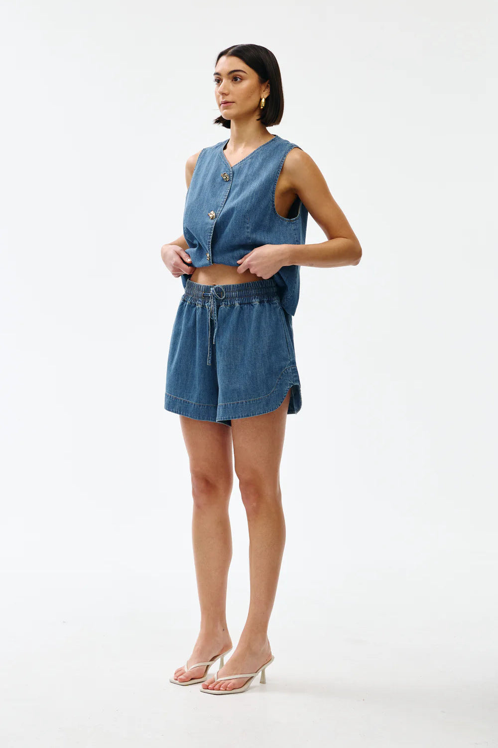 Woman wearing a denim outfit on a white background